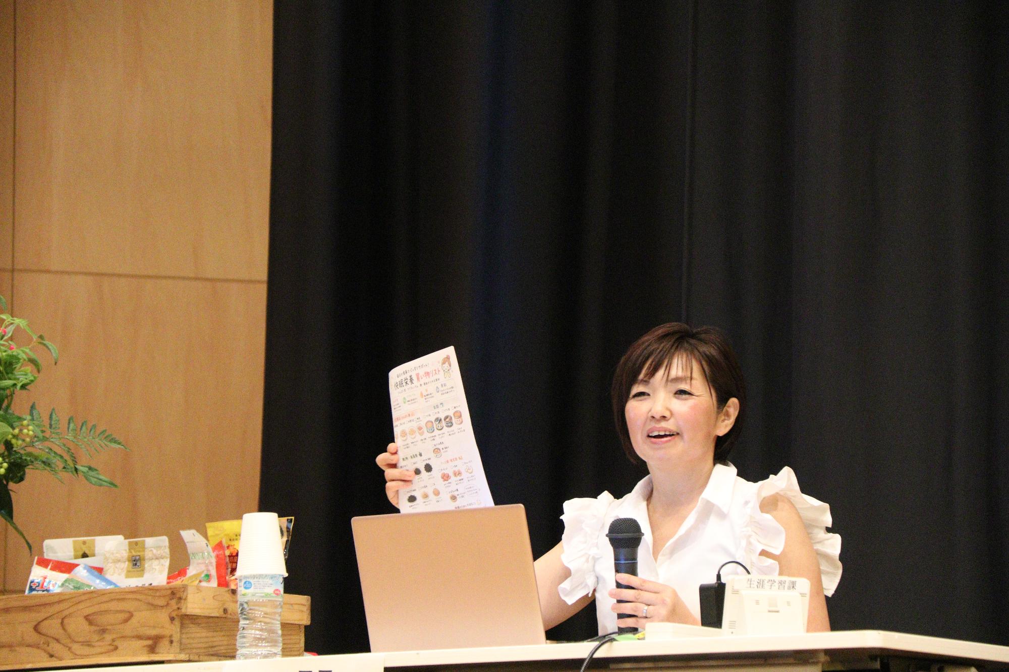 黒木道子先生が資料をもって話す様子